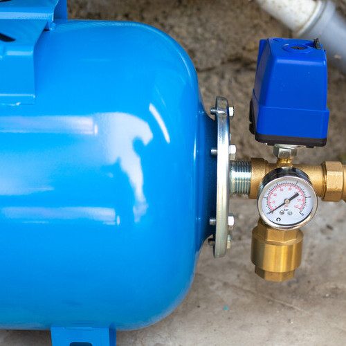 a blue booster pump on a concrete floor