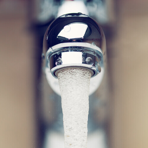 close-up of water pouring from a tap